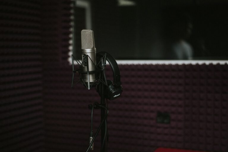 Micrófono con auriculares en una cabina de grabación tratada acústicamente