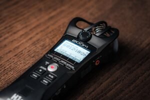 Primer plano de una grabadora de audio digital sobre una mesa de madera