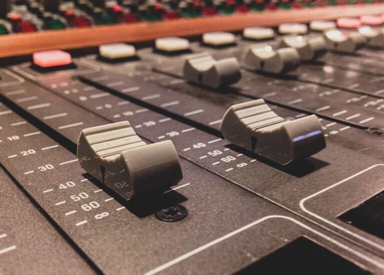 Faders y controles de una mesa de mezclas de estudio en primer plano